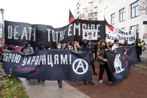anarchist demonstration with banner "death to the ampire"